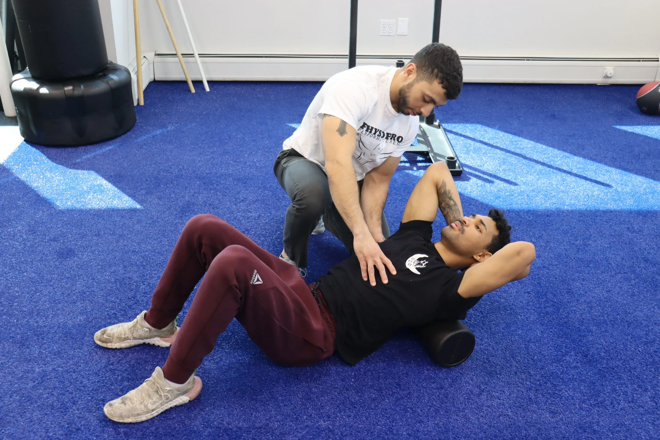 Physical Therapist guiding patient during his stretch
